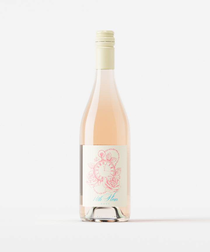 Bottle of 14th Hour Rose wine in burgundy shaped glass on a white background